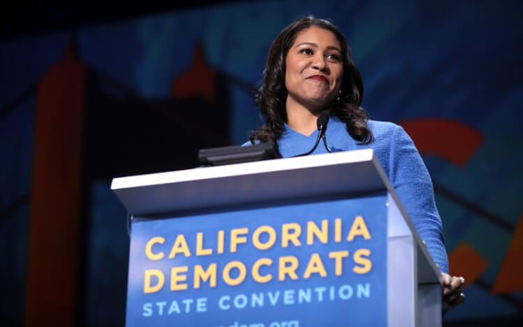 London Breed at podium that reads 