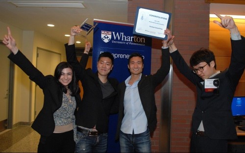 Team Slidejoy, founded by Wharton MBAs and an undergraduate, hold aloft their award