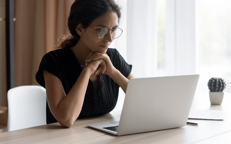 Woman on a computer. It takes three minutes to find out your business school application chances ©iStock