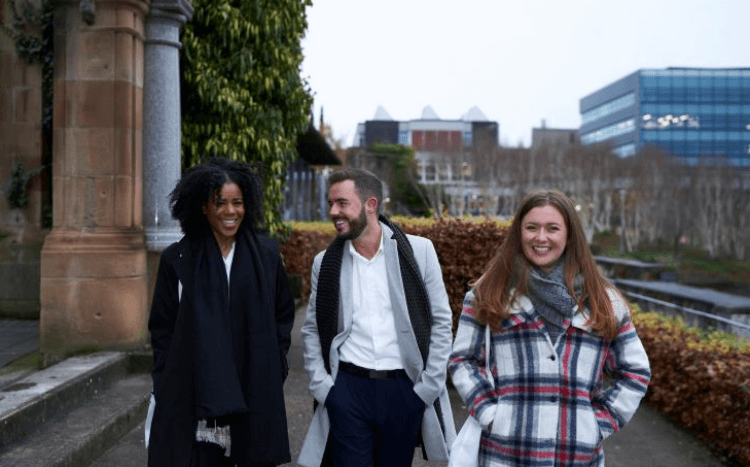 Three students pictured at Strathclyde Business School talking and laughing ©Strathclyde Business School / Facebook