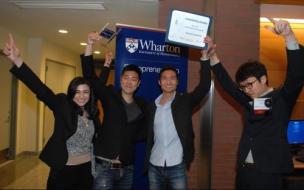 Team Slidejoy, founded by Wharton MBAs and an undergraduate, hold aloft their award