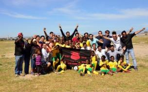 Students joined local kids in a game of soccer on a visit to Cape Town's Khayelitsha township